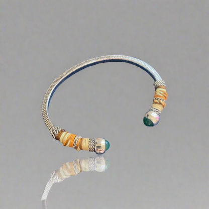 This adjustable bangle offers both style and versatility, with a width of 0.7cms and a circumference of 16.5cms. Elevate your wrist with this exquisite piece, perfect for adding a touch of artisanal charm to any ensemble.