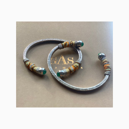 This adjustable bangle offers both style and versatility, with a width of 0.7cms and a circumference of 16.5cms. Elevate your wrist with this exquisite piece, perfect for adding a touch of artisanal charm to any ensemble.