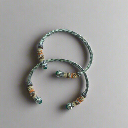 This adjustable bangle offers both style and versatility, with a width of 0.7cms and a circumference of 16.5cms. Elevate your wrist with this exquisite piece, perfect for adding a touch of artisanal charm to any ensemble.